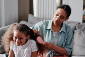 Mom brushing daughter's hair